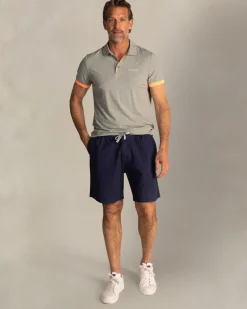 Grünes Poloshirt mit orangefarbenen Details